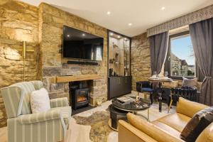 a living room with a stone wall at Just us Two - North East Escapes in Amble +25 photos