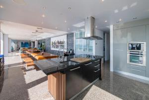 a kitchen with a large island with a counter top at Bluesiam Villa - SHA Certified in Surin Beach