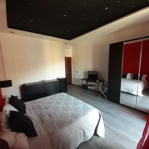 a bedroom with a large bed and a desk at Angela's house in Sulmona