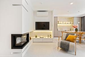 a living room with a tv and a fireplace at Casa Tucan Javea, luxury close to Arenal Beach in Jávea