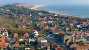 an aerial view of a small town next to the beach at Ooststraat 21 in Zoutelande