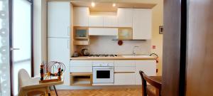 a small kitchen with white cabinets and a sink at Elle Palace - Simply Elegant in Verona