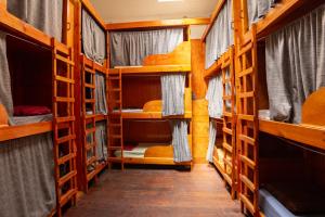a corridor of a room with bunk beds at Aotea Backpacker Hostel in Iquique