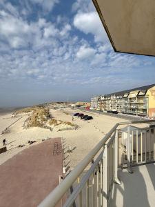 a view of the beach from a balcony at Les Sables 4 in Fort-Mahon-Plage +6 photos