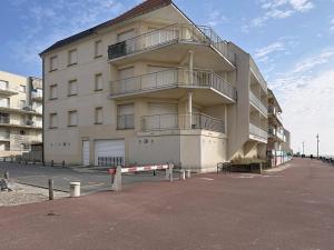a large white building with balconies on the side of it at Les Sables 4 in Fort-Mahon-Plage