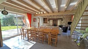 a dining room with a wooden table and chairs at Amboiras in La Croisille-sur-Briance