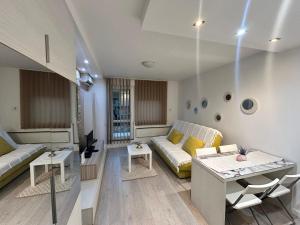 a living room with a couch and a table at Relax Apartment in Vrnjačka Banja