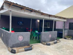 a house with a patio with a table and chairs at FE Purple Gold Hotel in Abuja
