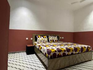 a bedroom with a large bed in a room at FE Purple Gold Hotel in Abuja