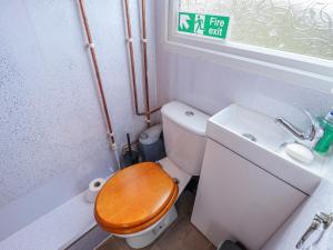 a small bathroom with a toilet and a sink at Riverside Cabin in Peterborough +6 photos