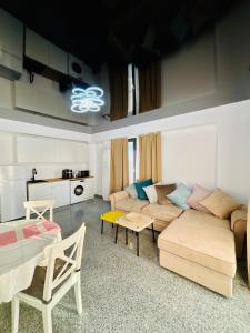 a living room with a couch and a table at B1 Apartments Deluxe in Năvodari