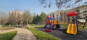 a playground in a park with a slide at Corps Rose Velley in Almaty