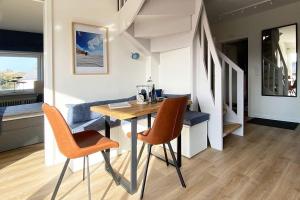 a dining room with a table and two chairs at Ferienwohnung-Sturmfri-e-se in Hörnum