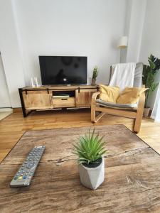 a living room with a flat screen tv and a chair at El Descanso del Cares in Arenas de Cabrales