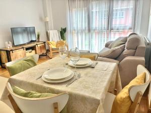 a living room with a table with wine glasses on it at El Descanso del Cares in Arenas de Cabrales