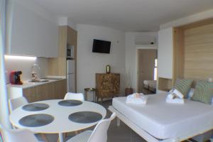 a kitchen and living room with a table and chairs at Agi Castell Mar in Roses