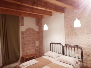 Postel nebo postele na pokoji v ubytování Palazzo Lupicini Affittacamere