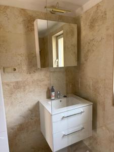 a bathroom with a white sink and a mirror at UKRYTY SKARB in Głobikówka +9 photos