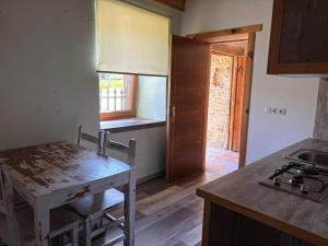 a kitchen with a table and a sink and a stove at O Viraventos in Betanzos