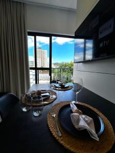 a table with two plates of food and wine glasses at RCM Vilas - Apartamento 306 in Joinville