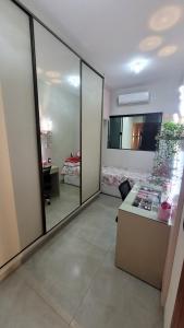 a room with a mirror and a desk and a bedroom at Casa Tecnoshow 2026 in Rio Verde