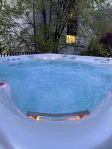 a jacuzzi tub with blue water in a backyard at Villa Hajdi Q & U in Merano