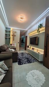 a living room with a couch and a tv at Casa Tecnoshow 2026 in Rio Verde