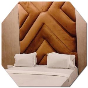 a bed in a box with two pillows on it at Shraddha Hotel in Alīgarh