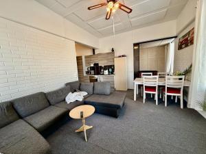 a living room with a couch and a table at Casa de Fit in Joensuu