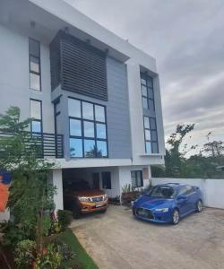 a blue car parked in front of a house at Private Room at MA Compound in Concepcion