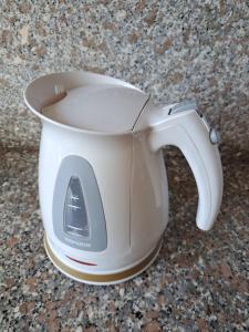 a white coffee cup sitting on top of a counter at KANALU Land in Bouillante