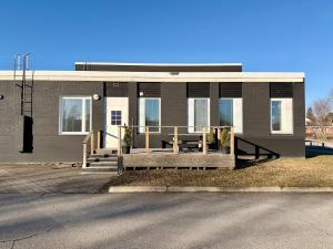 a house with a wooden porch in front of it at Casa de Fit in Joensuu