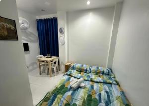 a small bedroom with a bed and a bathroom at Private Room at MA Compound in Concepcion