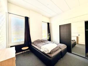 a bedroom with a bed in a room with a window at Casa de Fit in Joensuu