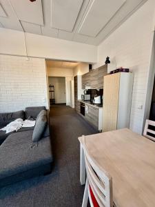 a room with a couch and a table and a kitchen at Casa de Fit in Joensuu