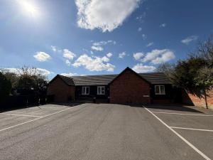 an empty parking lot in front of a brick building at The Red Lion Bed and Breakfast in Kings Walden