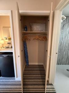 a hallway with a staircase leading up to a closet at The Red Lion Bed and Breakfast in Kings Walden