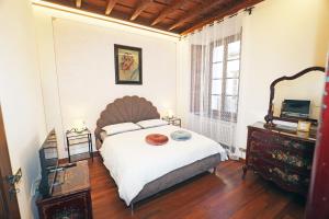 a bedroom with a large bed and a mirror at Casa Olaf in Cannobio