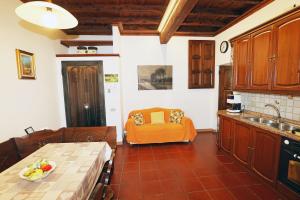 a kitchen with an orange couch in the corner of a room at Casa Olaf in Cannobio