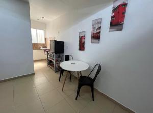 a dining room with a table and a red bus on the wall at STUDiOS RAYON in Morelia