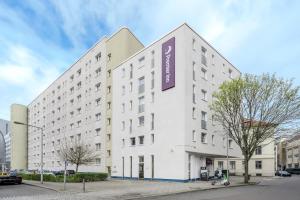 a large white building with a purple sign on it at Premier Inn Berlin City Spittelmarkt in Berlin