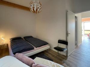 a bedroom with a bed and a chair in it at Appartamento Ato La Gerbia in Cannobio