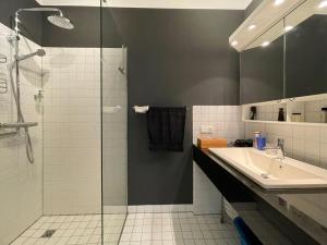 a bathroom with a glass shower and a sink at Appartamento Ato La Gerbia in Cannobio +20 photos