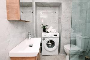 a bathroom with a washing machine and a toilet at Dolce Casa in Corfu