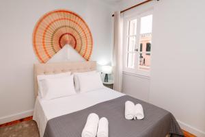 a bedroom with a bed with white slippers on it at Dolce Casa in Corfu