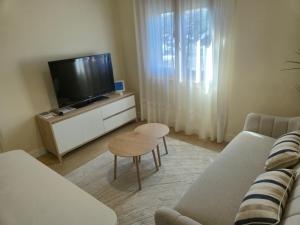 a living room with a couch and a tv at Casa Anita in Luarca