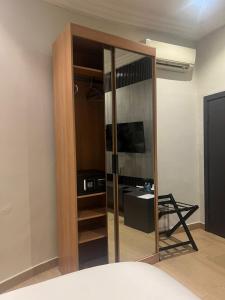 a room with a glass partition with a sink and a desk at Hirolagos in Bamgbose