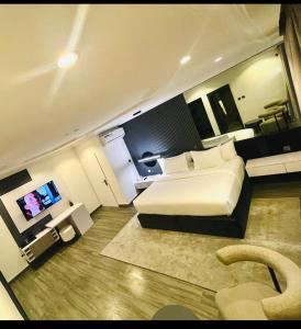 a hotel room with a bed and a television at Hirolagos in Bamgbose