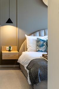 a bedroom with a bed with a nightstand next to it at Casa Tucan Javea, luxury close to Arenal Beach in Jávea