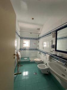 a bathroom with two sinks and two toilets in it at Hotel Sole in Maiori +30 photos